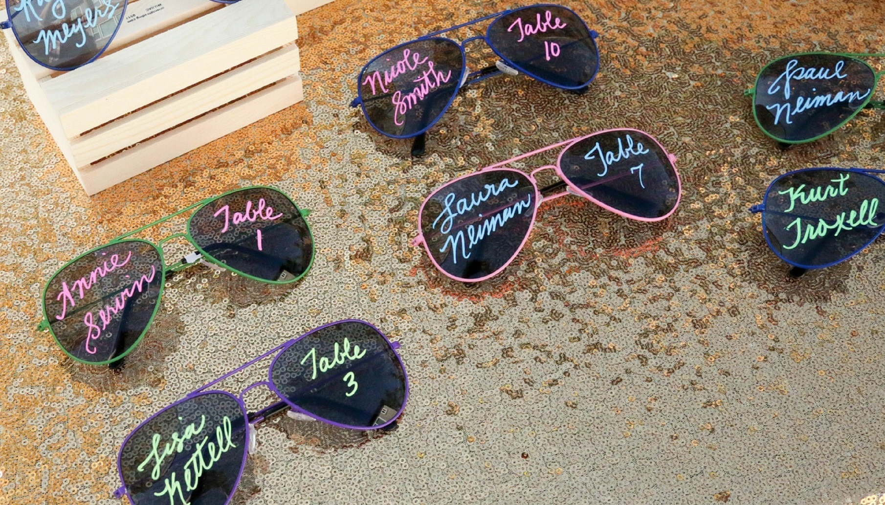 creative escort card display uses sunglasses for table assignments