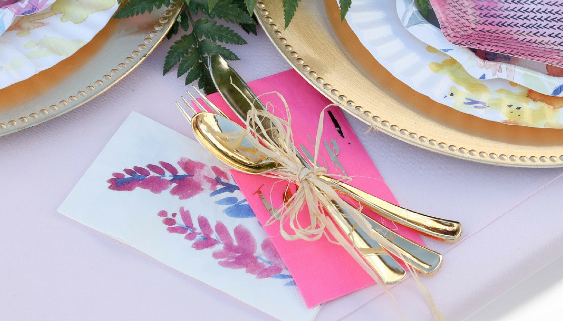 fluorescent pink napkin and raffia tied cutlery