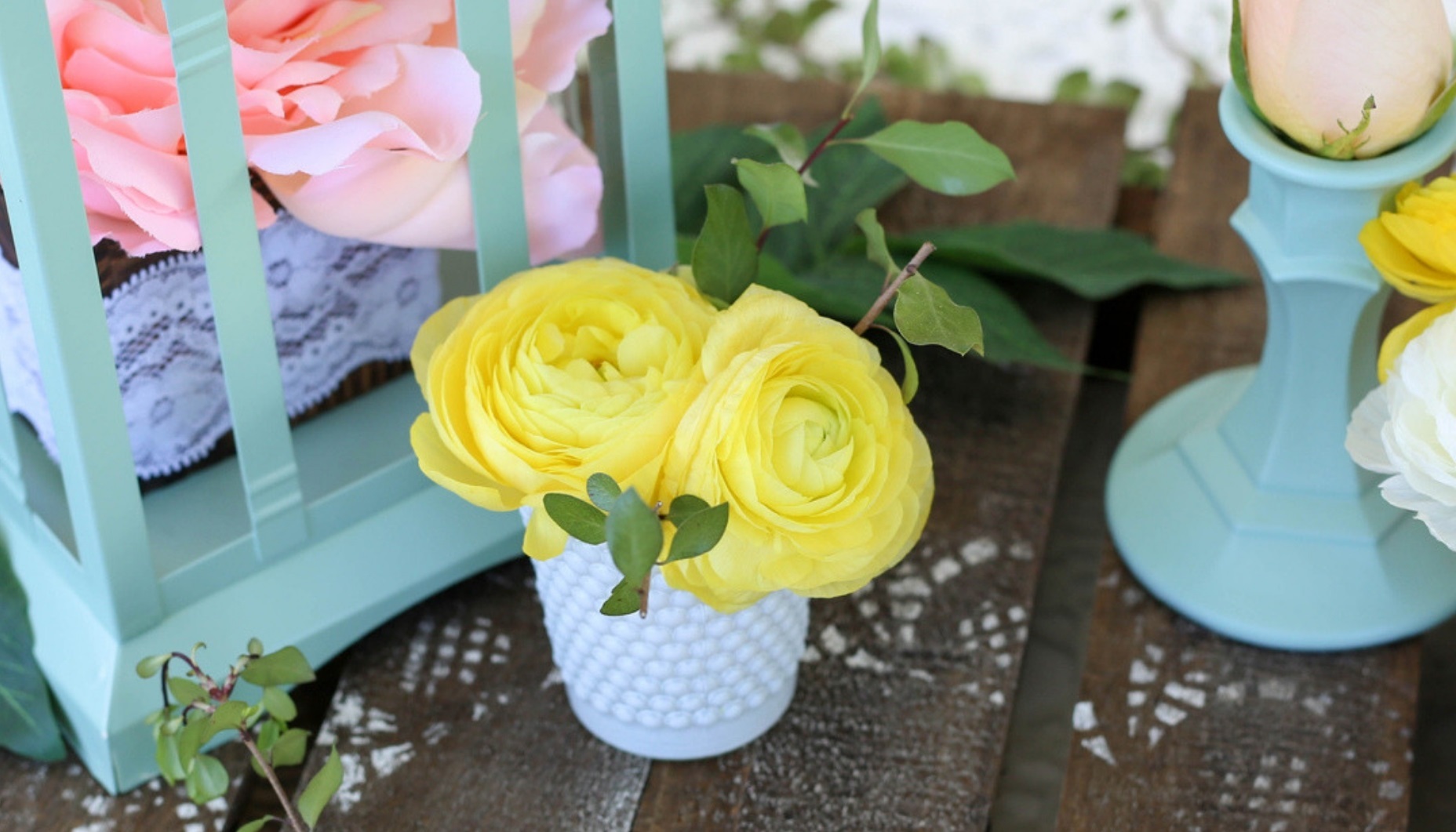flowers in a hobnail glass votive cup