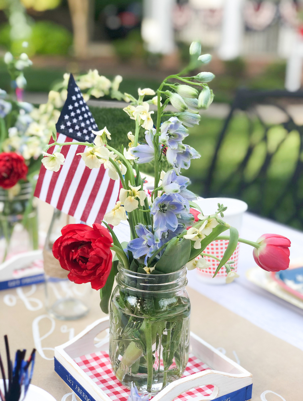 Fill a simply mason jar with pretty red, white and blue flowers for a stunning centerpiece idea
