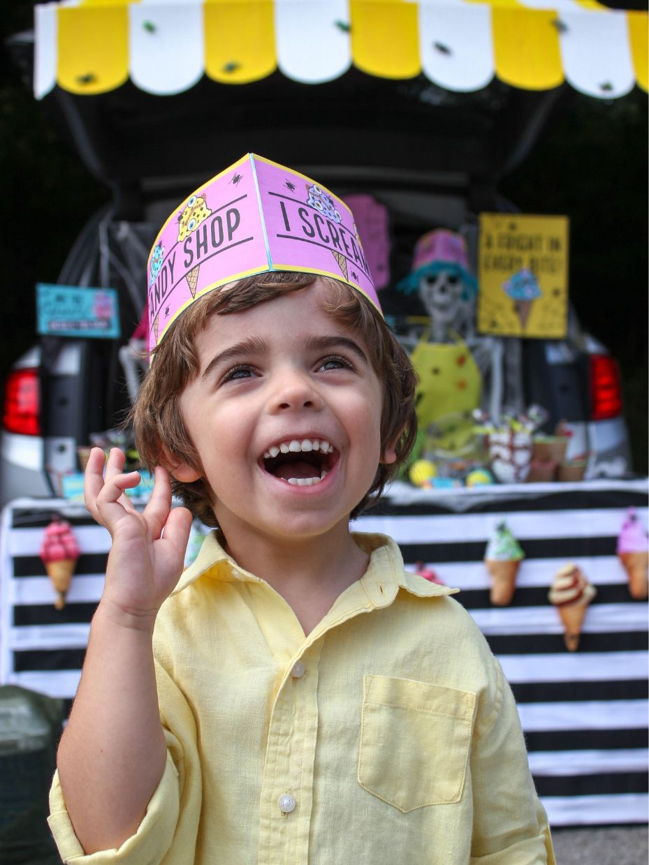 boy wearing ice cream shop paper hat
