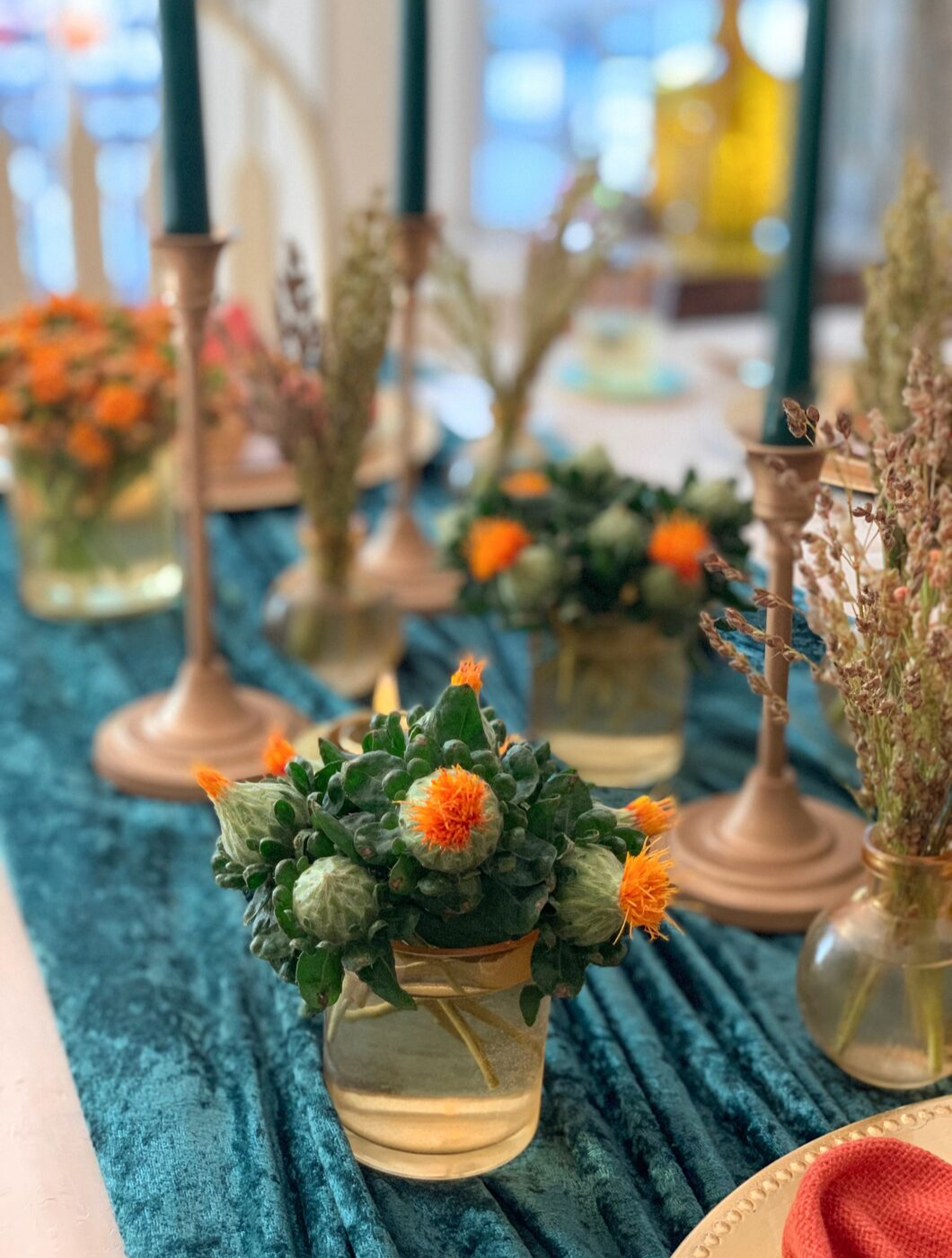 Learn how a simple combination of candles, votives and fresh flowers can create a stunning Thanksgiving centerpiece!