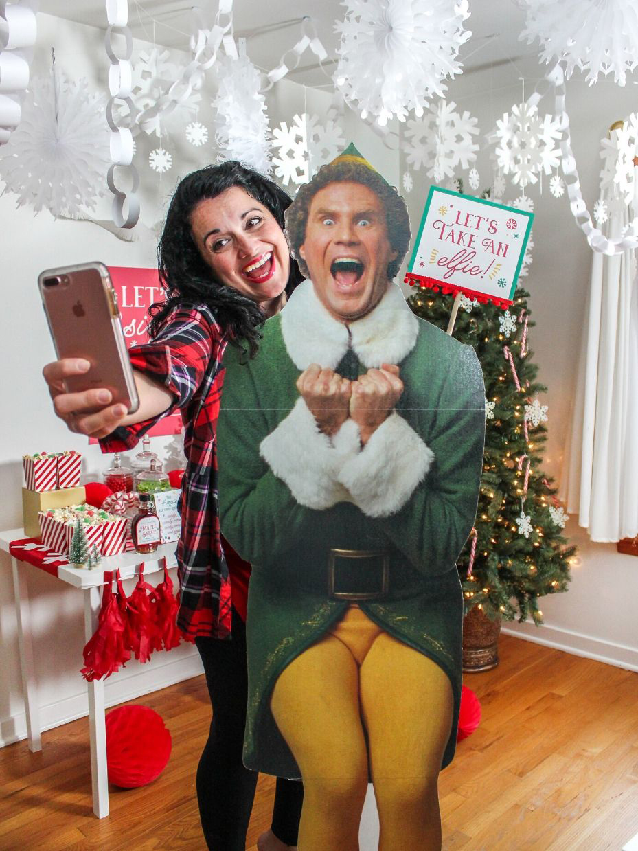 Woman taking selfie with Buddy the Elf