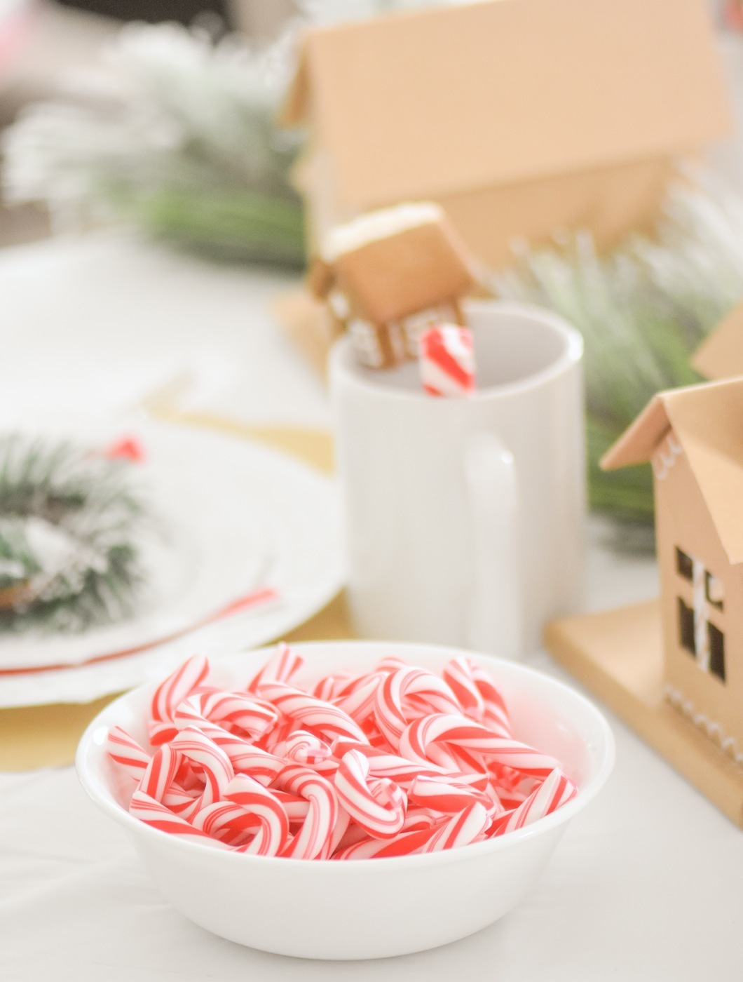 Candy Canes for Decorating Guessing Game at Gingerbread House Holiday Christmas baby shower table and ideas