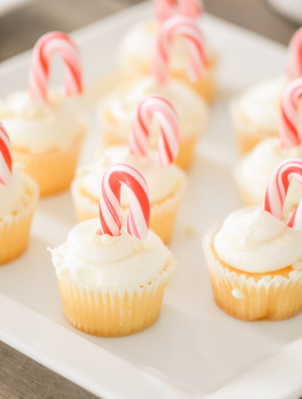 mini cupcakes with candy canes on a baby shower dessert table