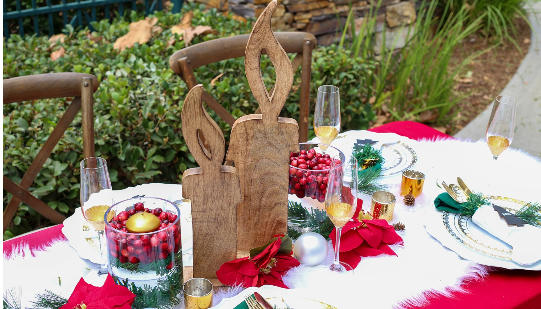 Wood candles rustic stain paired with glass hurricane vases with cranberry and pine for a Christmas wedding