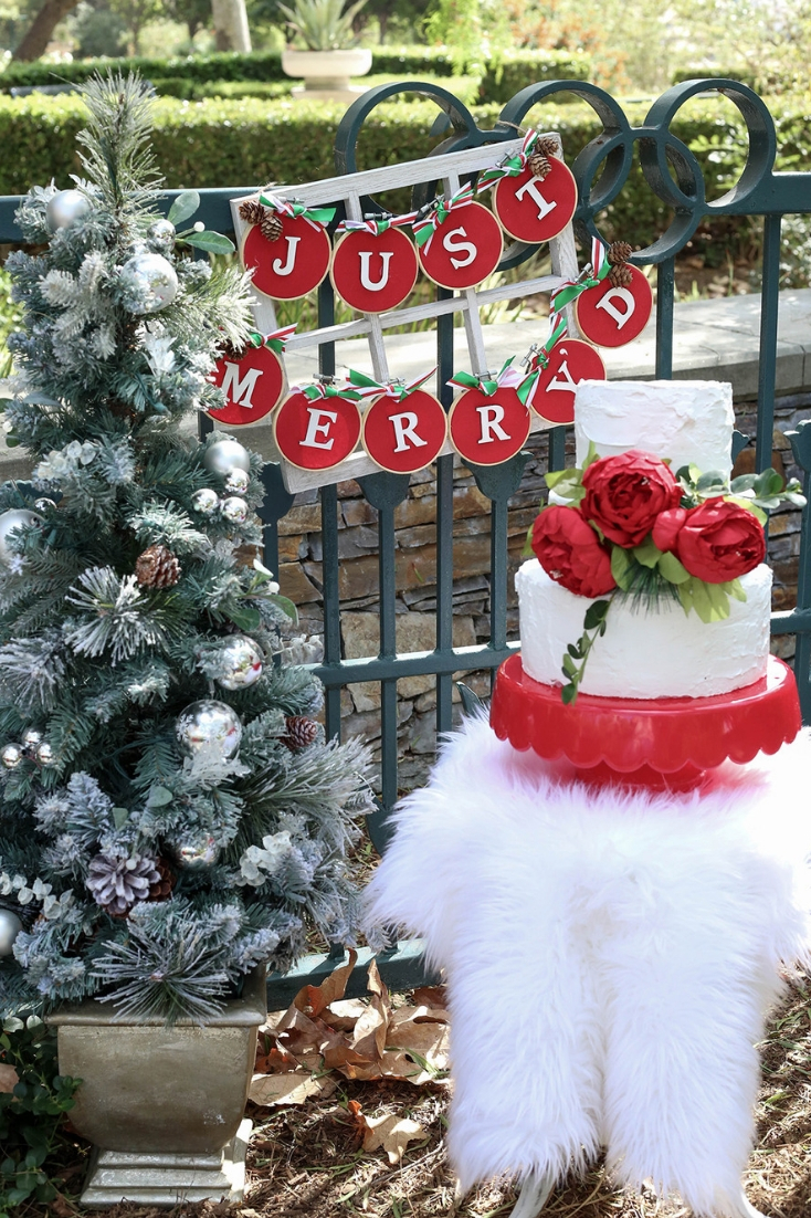 Christmas wedding cake on red cake stand and small christmas tree Just Merryd DIY sign tutorial