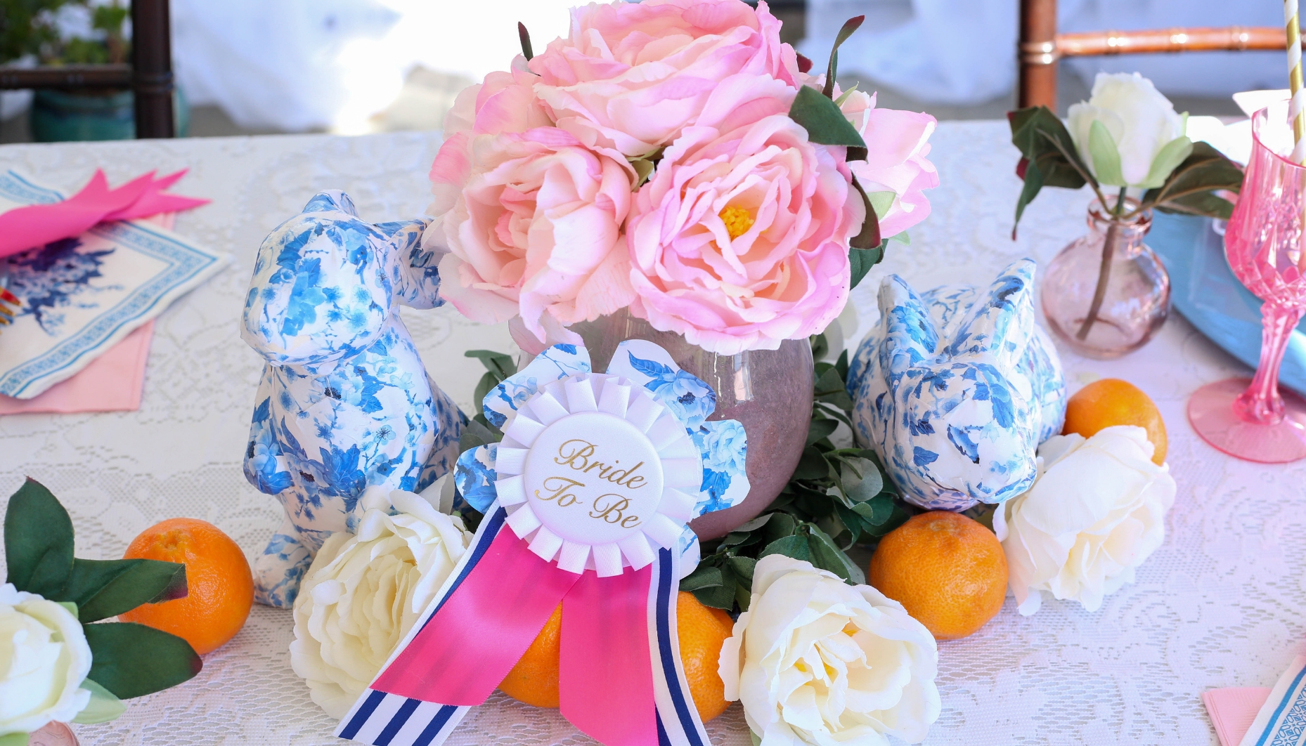 Spring bridal party or Easter Tablescape with blue patterned bunnies, peonies and tangerines