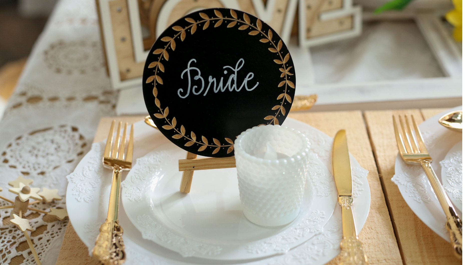 Laurel leaf chalkboard place setting for bride on a wood charger for sunflower themed wedding with rustic touches