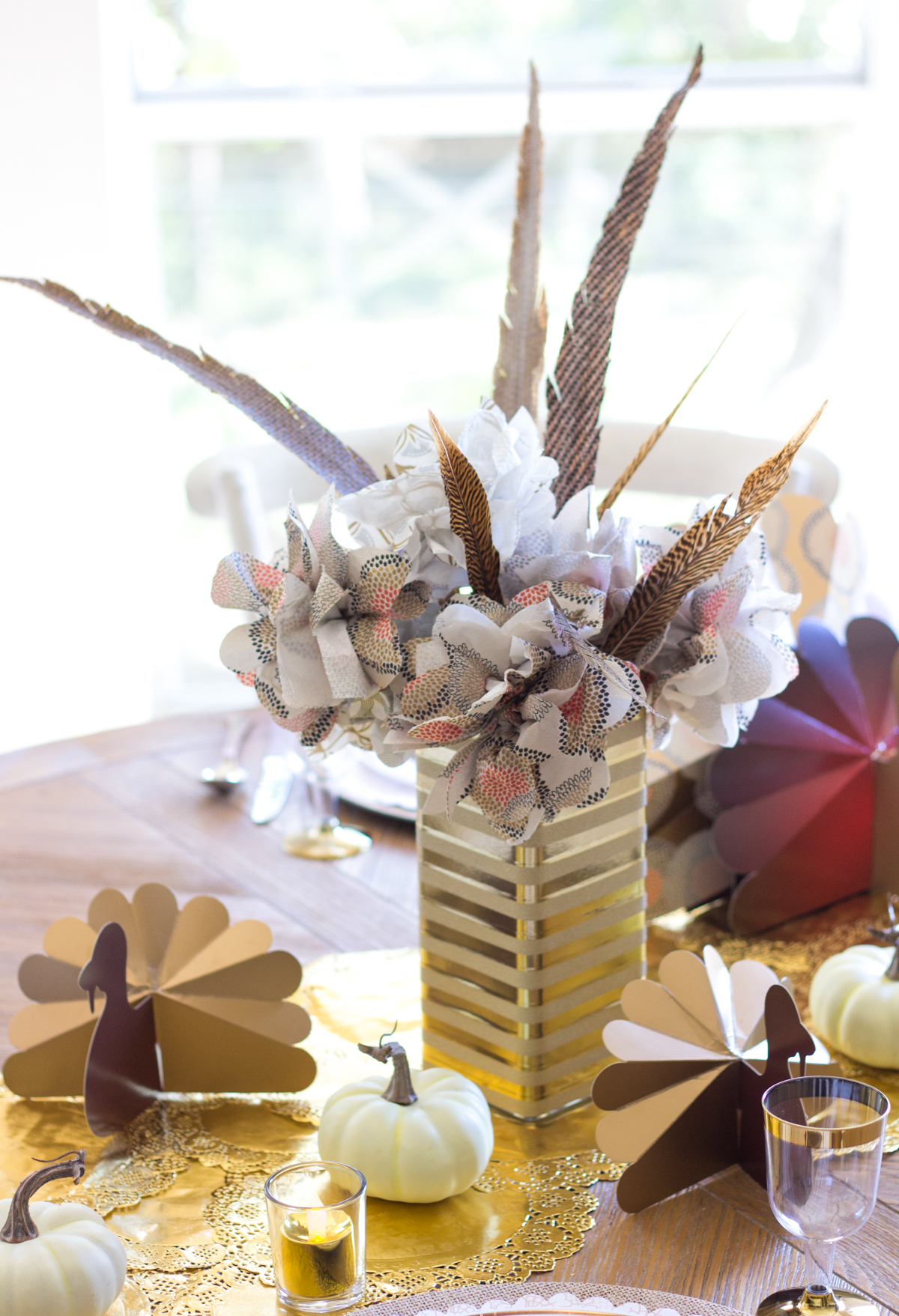 Thanksgiving centerpiece idea with paper flowers and feathers