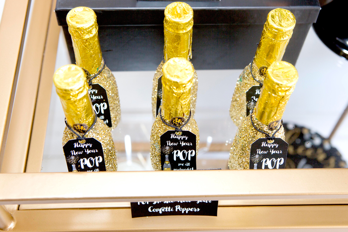 Gold Glitter dipped champagne bottle. Party Popper with glitter for new years eve.