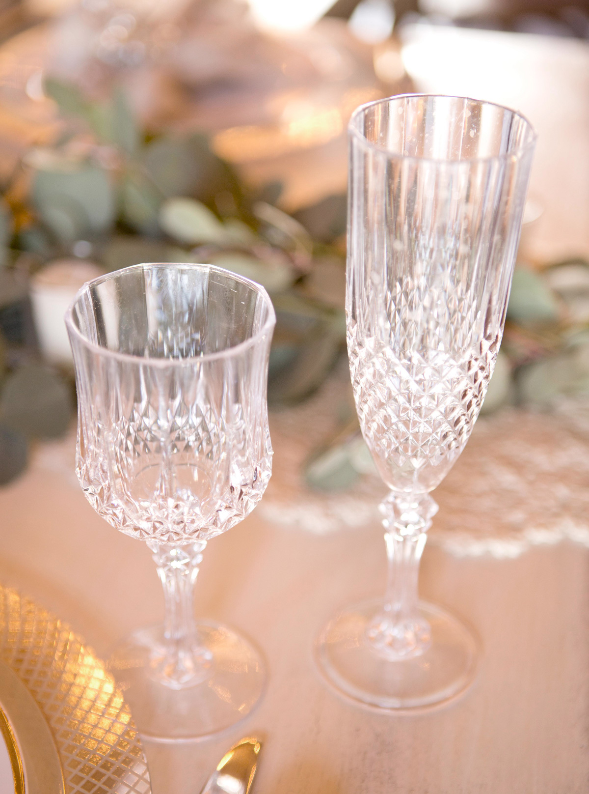 Plastic and elegant wine and champagne glasses for a wedding