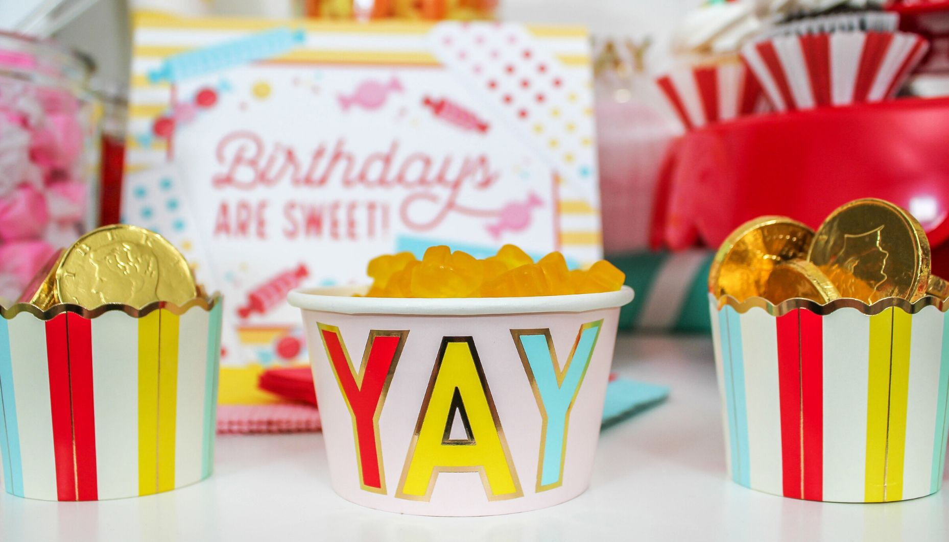 Close up of food cups and yay ice cream cup filled with candy