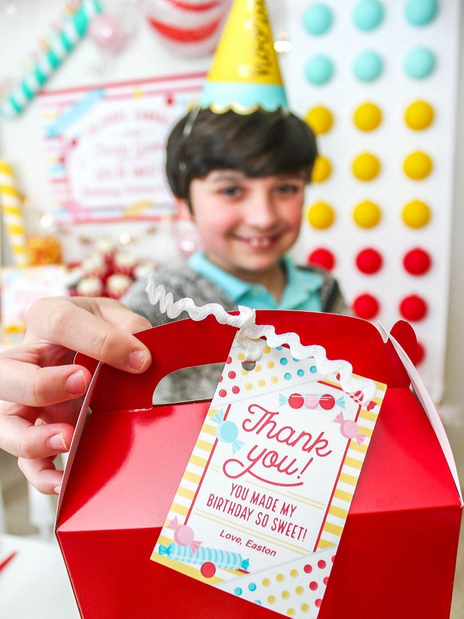 boy holding a favor box with a thank you tag