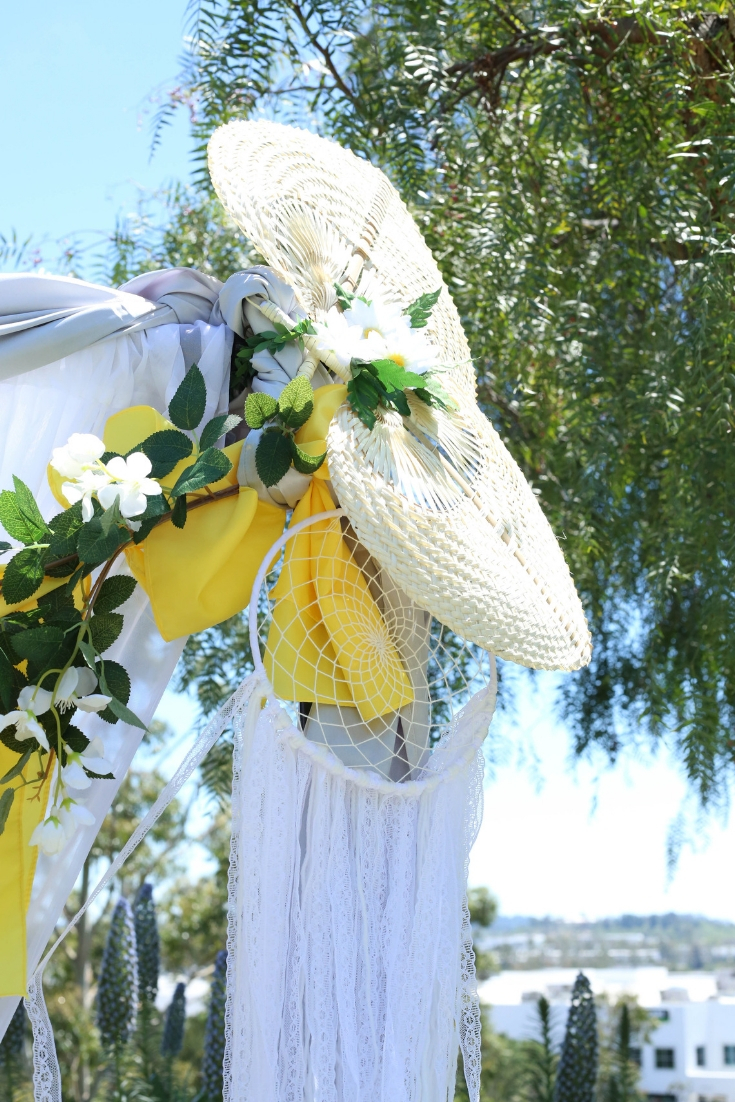 bohemian wedding details like dreamcatchers go well with a daisy themed wedding. Bohemian weddin dreamcatcher on a ceremony backdrop with daisies.
