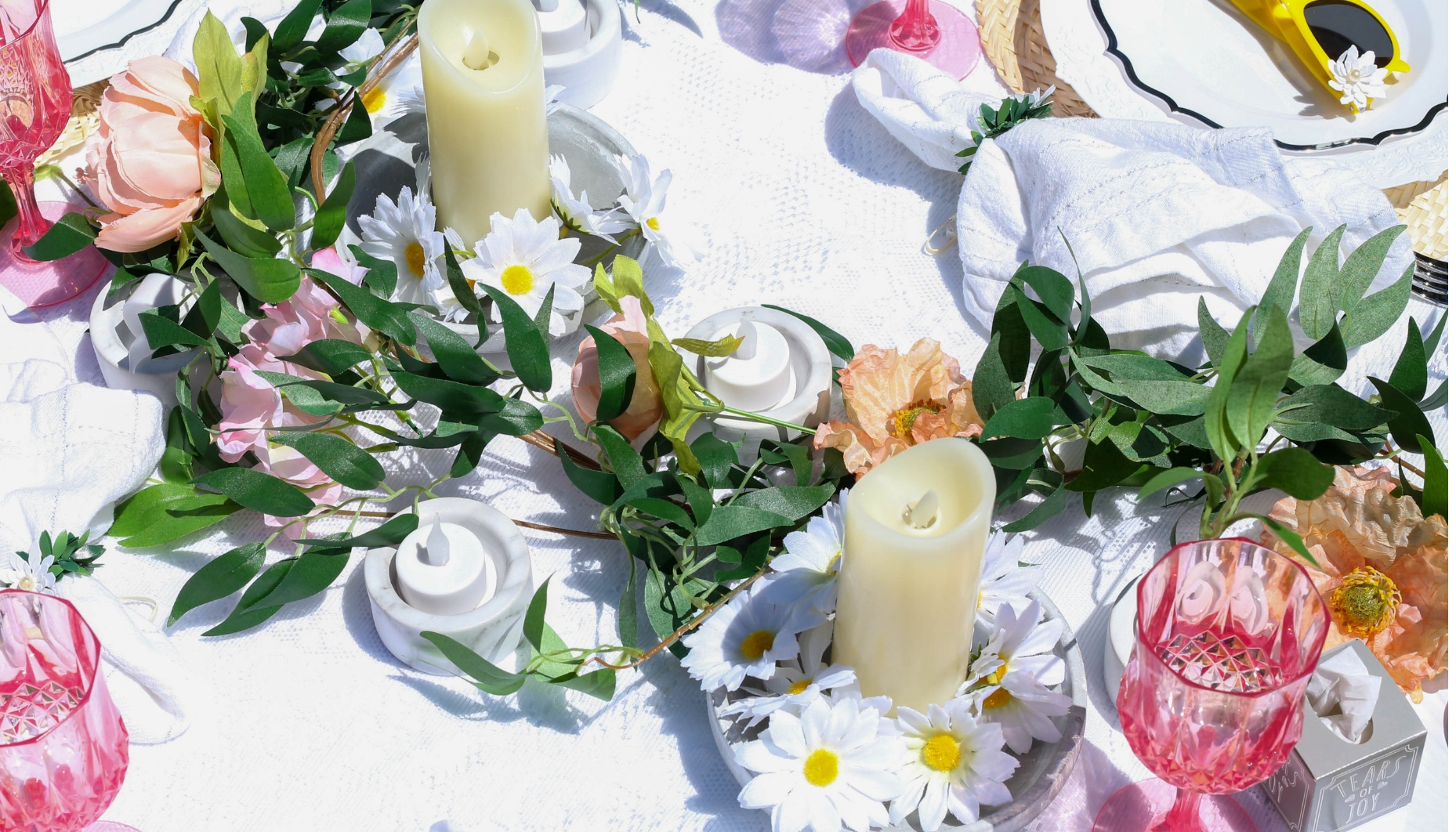 daisy wedding centerpiece with greenery daisy garland and greenery centerpiece with candles in concrete containers with daisies and votive candles