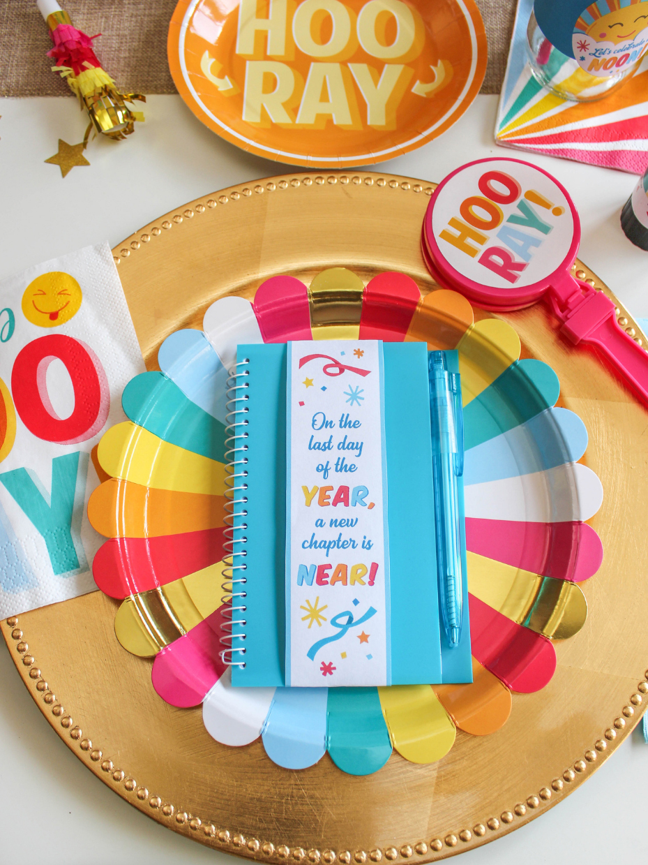 Place setting with notebook favor