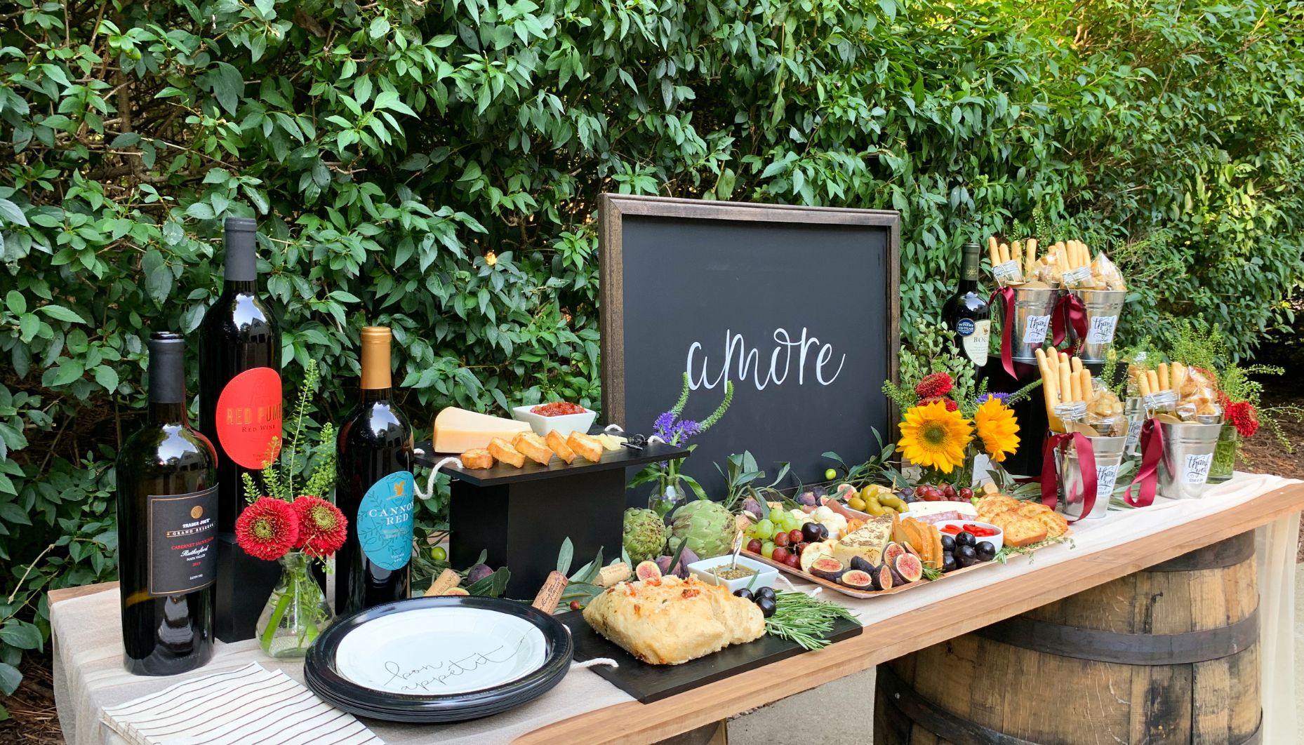 Wines, cheeses, fruits and crostinis work together to create a gorgeous food display for an Italian Bridal Shower.